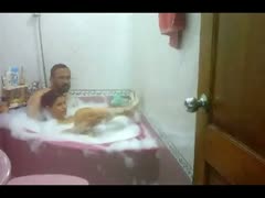 A plump Indian lady and her husband in the shower together